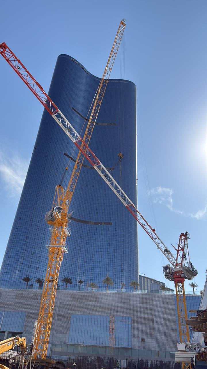 Maintenance crew servicing crane mechanical systems on an Abu Dhabi project.