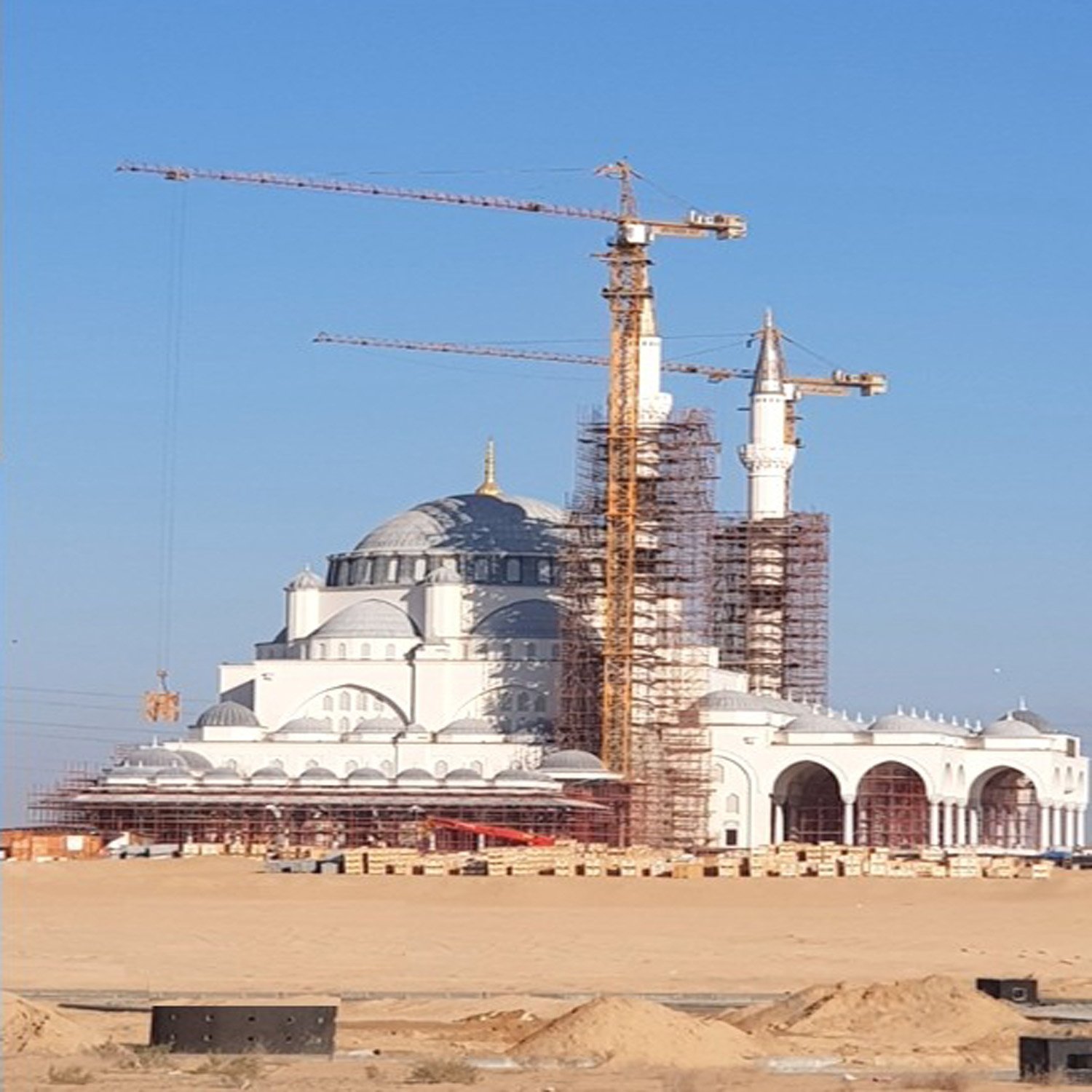 Sharjah project with cranes positioned around a major mixed-use development.