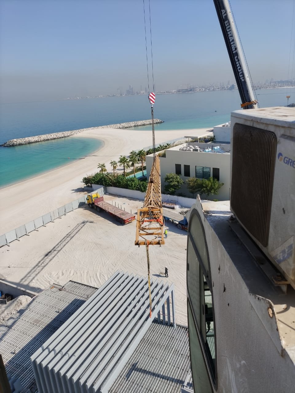 Crane operation lifting tower crane components into position during installation activity.